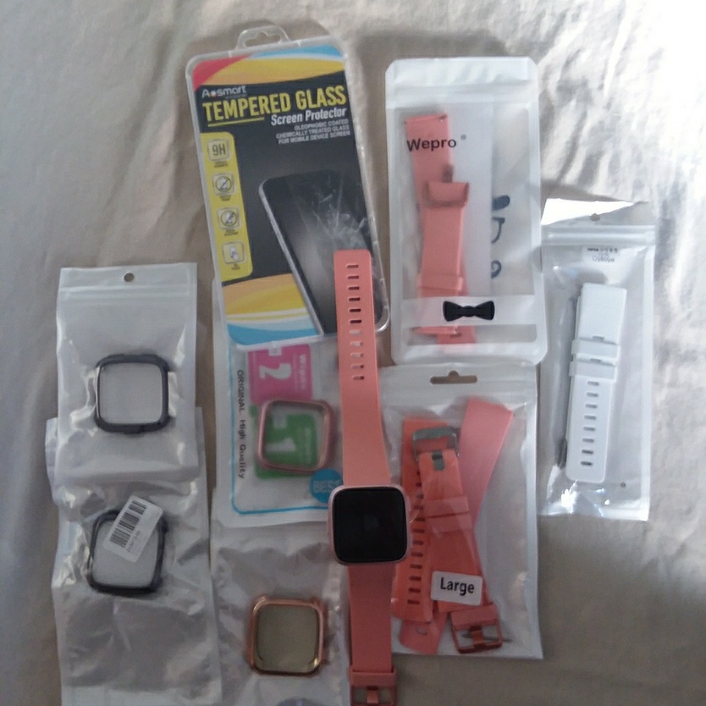New Fitbit Versa with assortment of accessories.